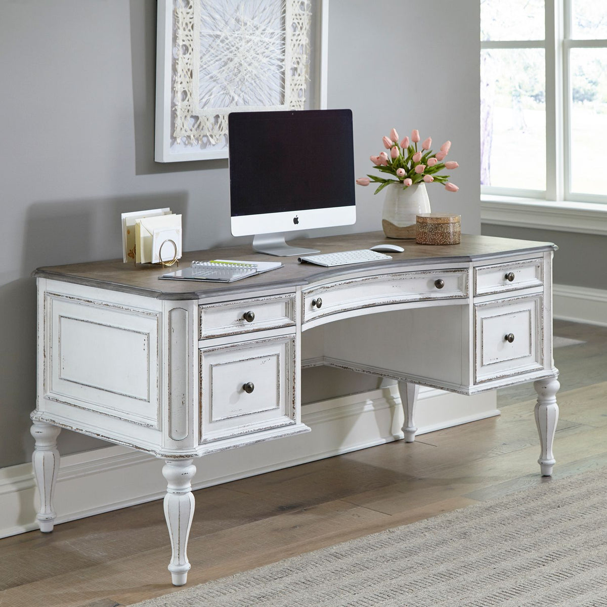 White farmhouse writing desk with drawers in a home office